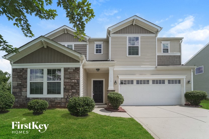 a house with a garage door and a driveway