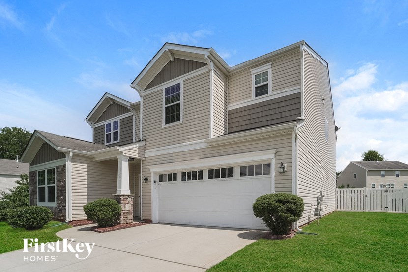 a white house with a white garage door