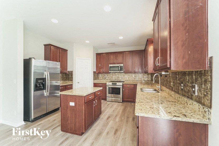a kitchen with wooden cabinets and stainless steel appliances
