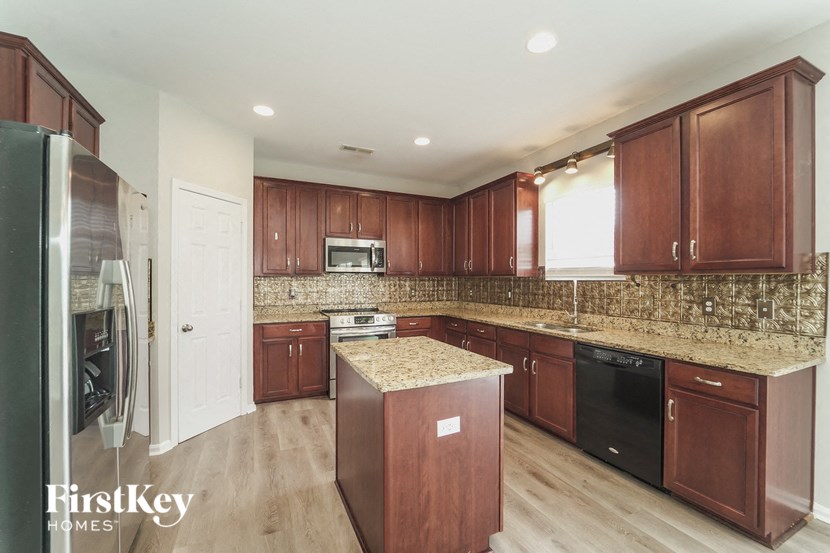 a kitchen with wooden cabinets and granite counter tops