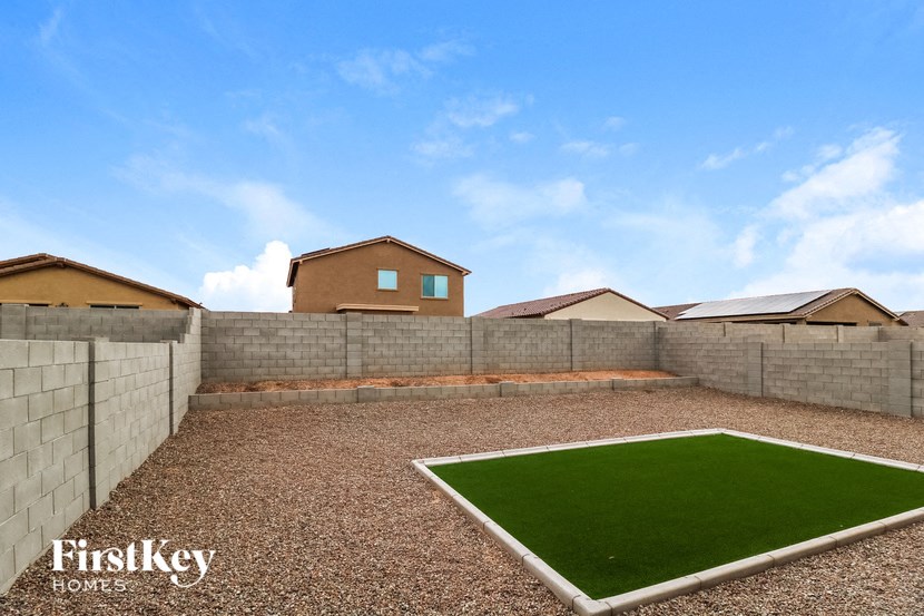 a turf lawn in the backyard of a house