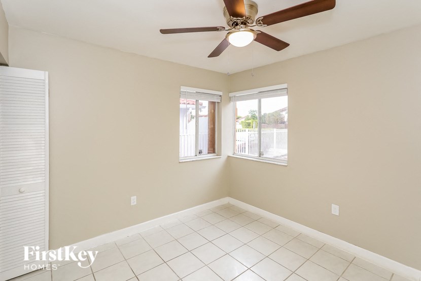 A room with a ceiling fan and a window.