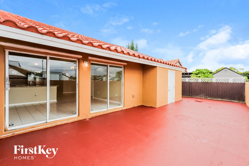 A red building with a FirstKey Homes sign on it.