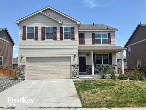 A two-story house with a garage is for sale by FirstKey Homes.