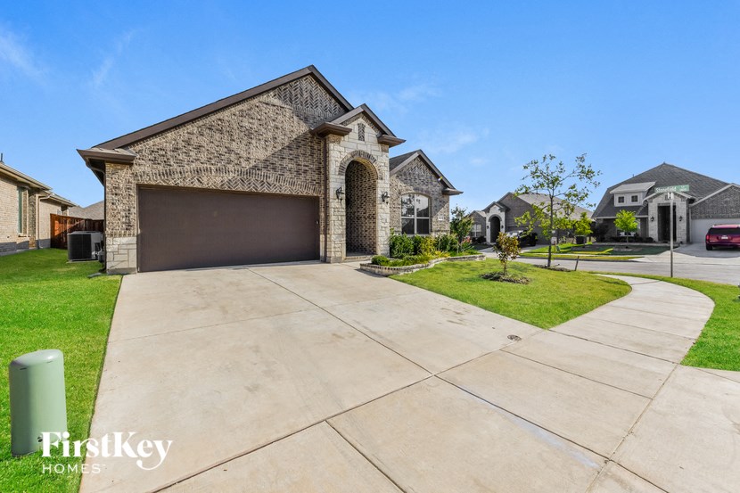 a large house with a driveway and a garage door