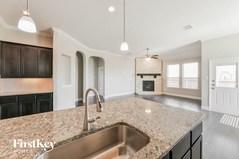a kitchen with granite counter tops and a sink