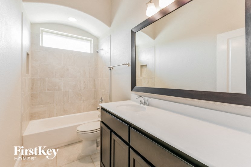 a bathroom with a sink and a toilet and a shower