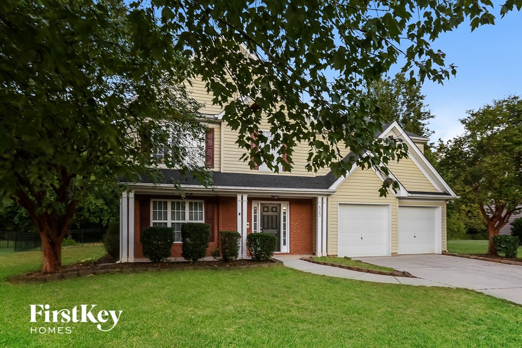A house with a tree in front of it.
