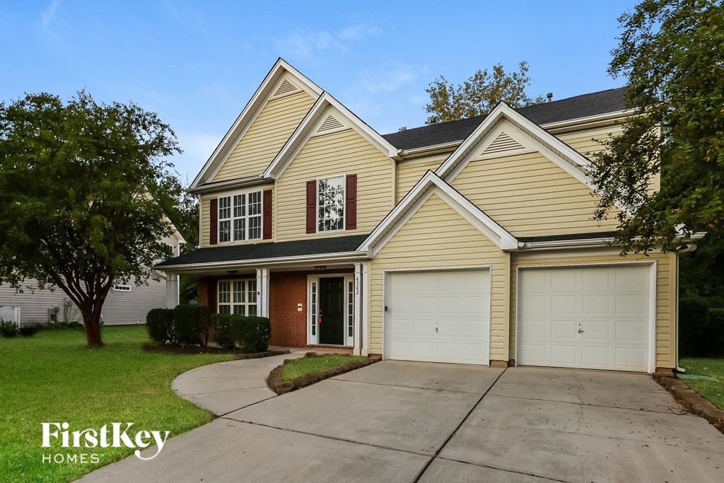 A two-story house with a garage is for sale.