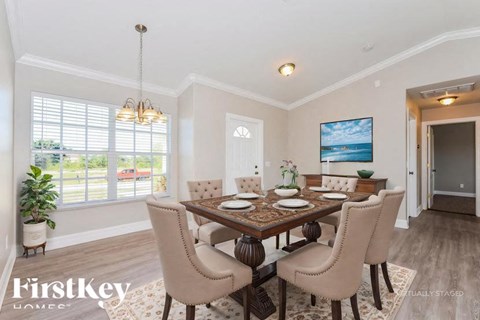 A dining room with a wooden table and chairs.