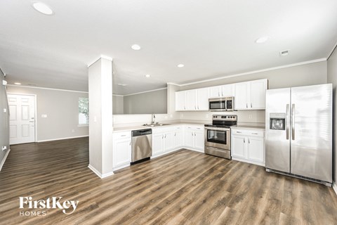 a kitchen with white cabinets and stainless steel appliances