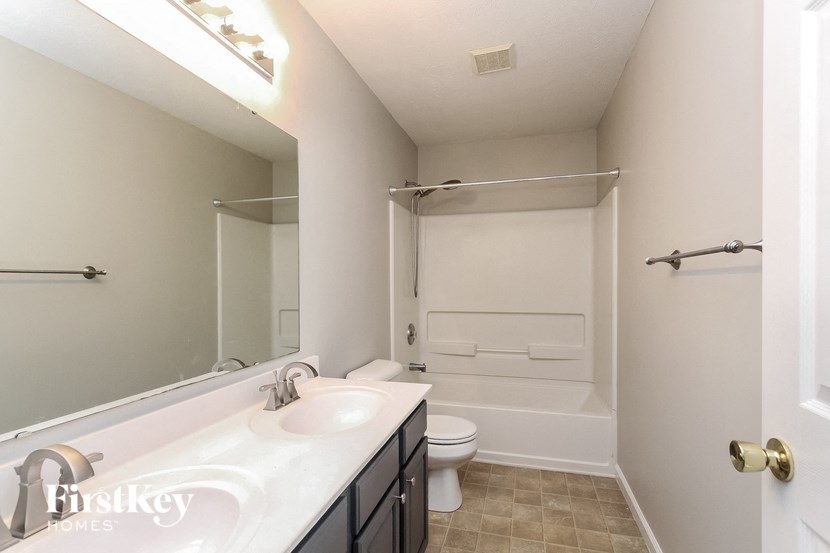 a bathroom with a sink and a shower and a toilet