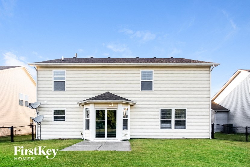 a white house with a lawn and a door