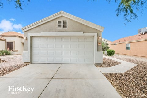 A house with a white garage door in front of it.