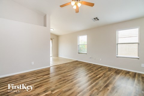 A room with wooden floors and a ceiling fan.