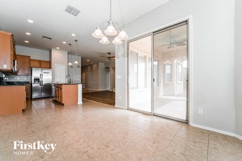A kitchen with wooden cabinets and a tiled floor.