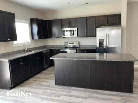 a kitchen with stainless steel appliances and black cabinets