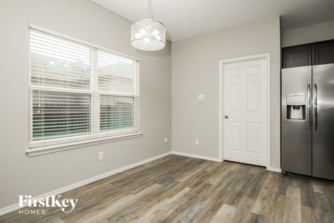 a kitchen with a refrigerator and a large window