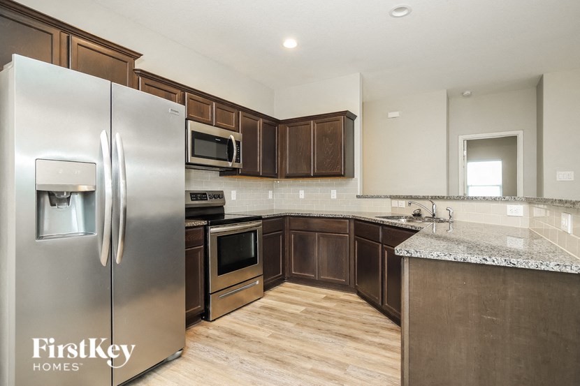 a kitchen with stainless steel appliances and wooden cabinets