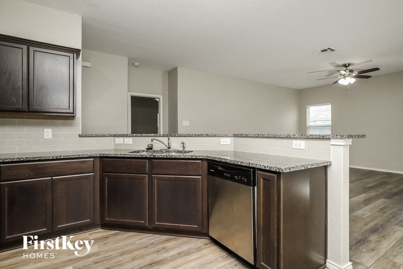 a kitchen with wooden cabinets and a counter top