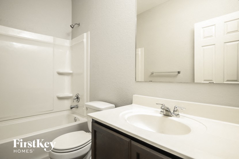 a white bathroom with a sink toilet and bath tub