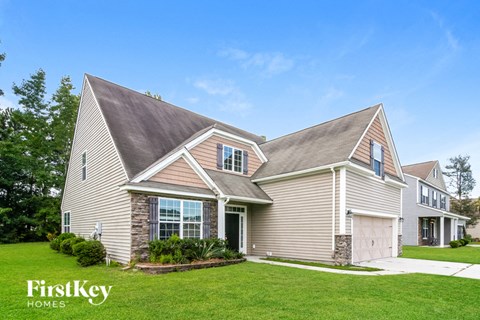 a house with a lawn and a garage
