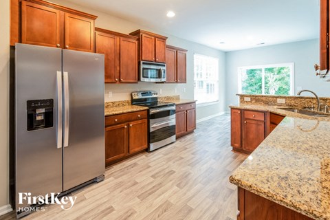 a kitchen with stainless steel appliances and wooden cabinets