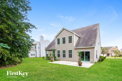 a white house with green grass and a yard