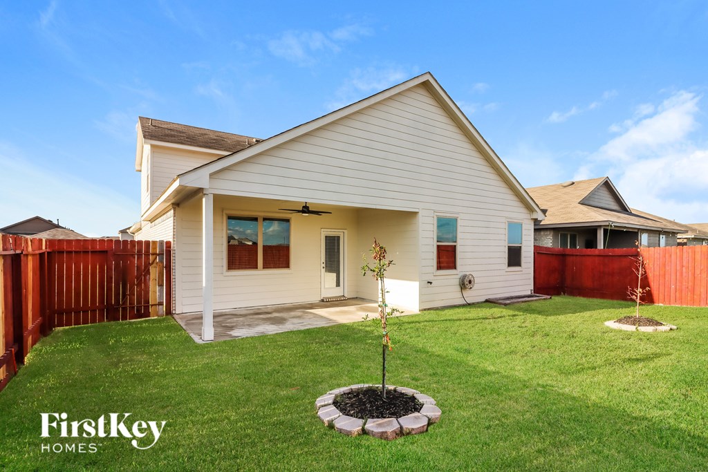 A house with a tree in a small garden.
