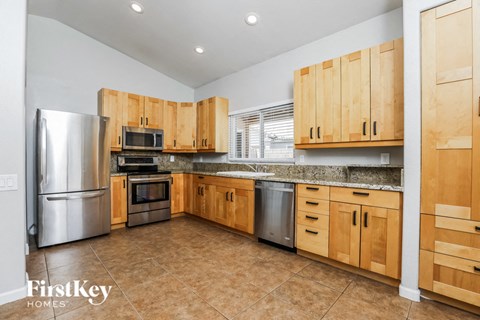 a kitchen with wooden cabinets and stainless steel appliances