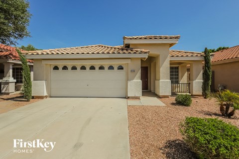 a house with a white garage door and a driveway