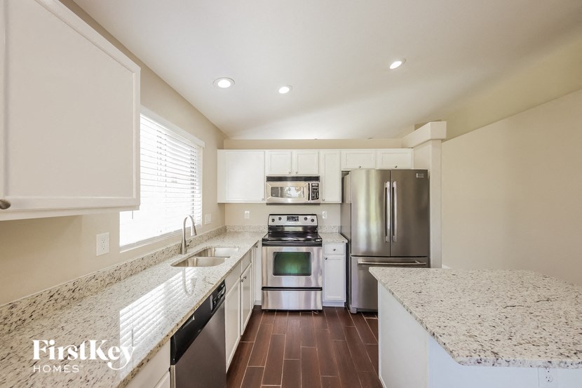 a kitchen with granite counter tops and stainless steel appliances