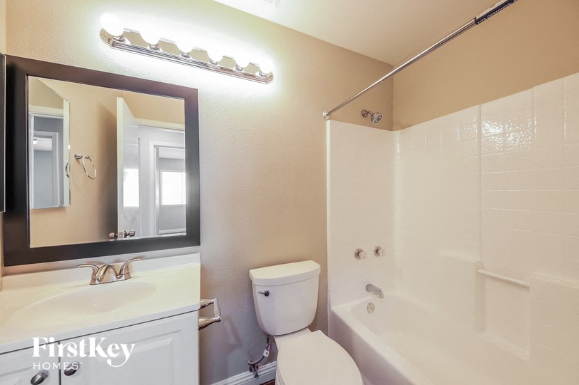 a bathroom with a tub and a toilet and a sink