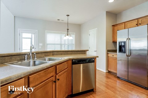 A kitchen with wooden cabinets and stainless steel appliances.