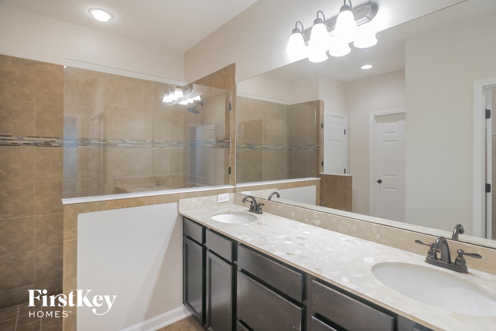 a bathroom with two sinks and a large mirror