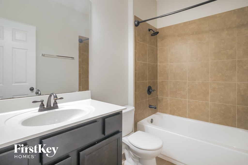 a bathroom with a sink and a toilet and a tub