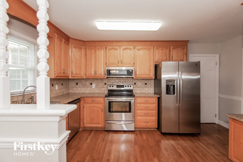 a kitchen with wooden cabinets and stainless steel appliances