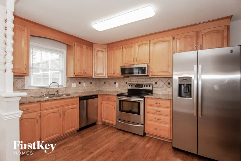 a kitchen with wooden cabinets and stainless steel appliances