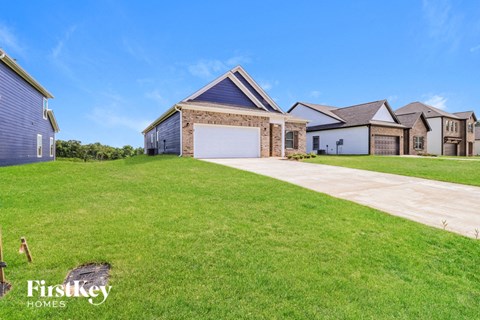 A large, well-maintained house with a driveway in front.