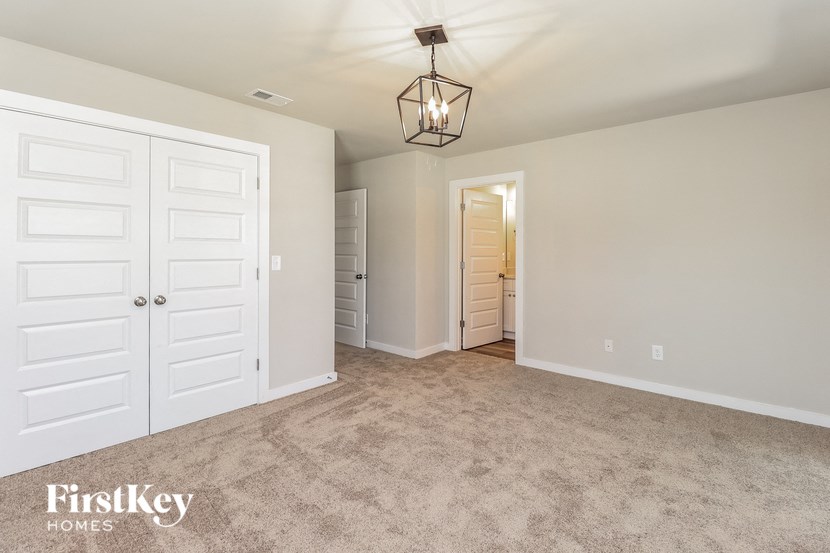 a bedroom with a closet and a white door