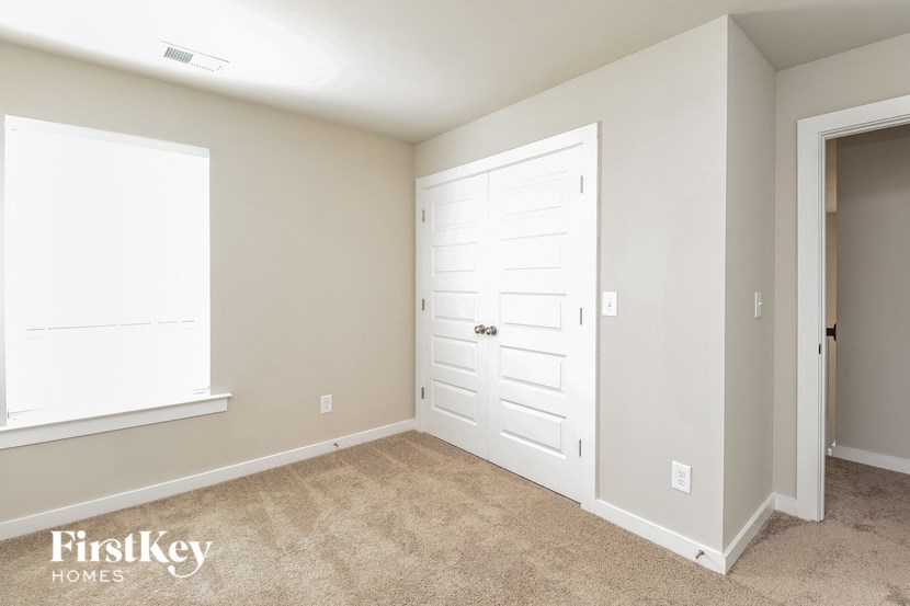 a bedroom with a closet and a white door