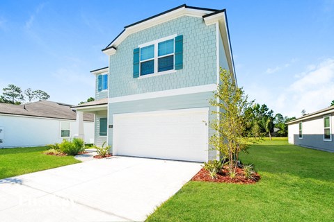 A house with a white garage door and a blue wall.