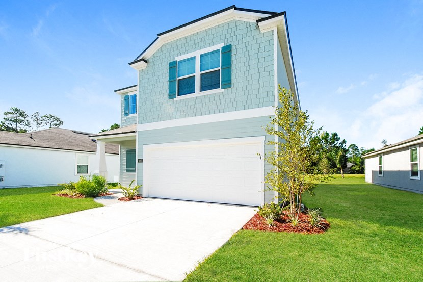 A house with a white garage door and a blue wall.