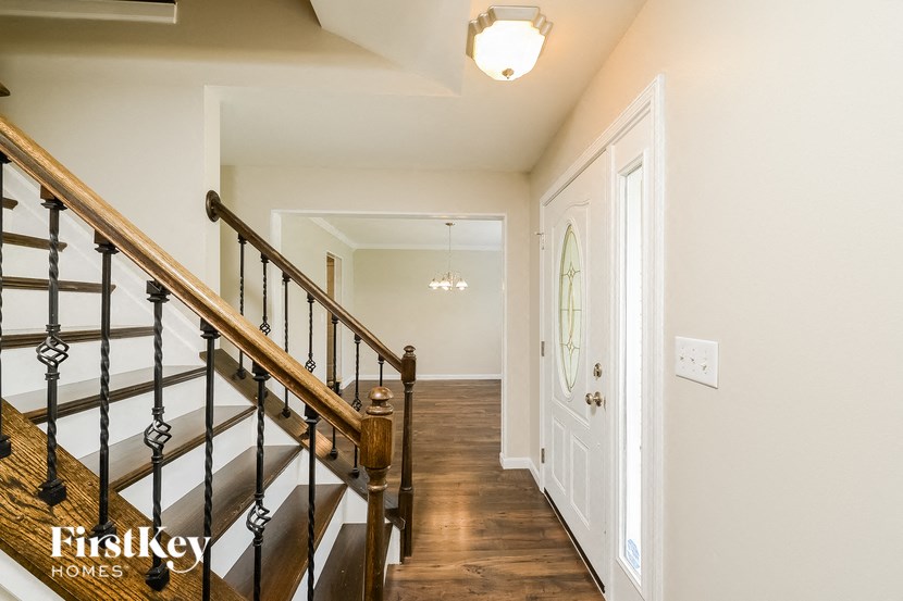 a stairway in a home with a white door and a door to a hallway