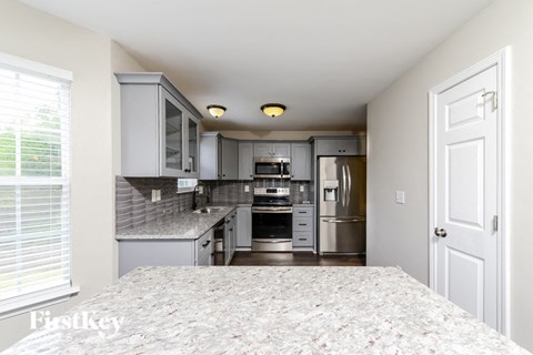 a kitchen with stainless steel appliances and granite counter tops