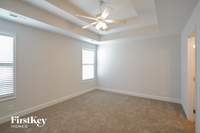 a bedroom with a ceiling fan and a window