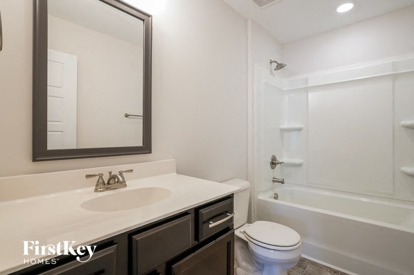 a bathroom with a sink and a toilet and a shower