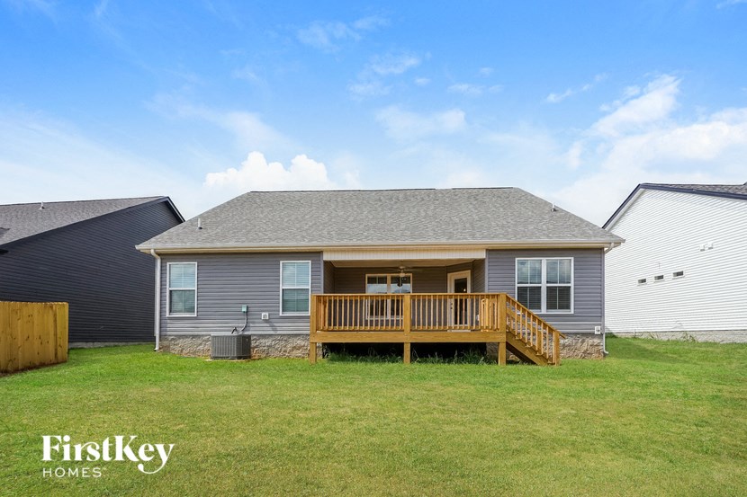 a manufactured home with a deck and a yard