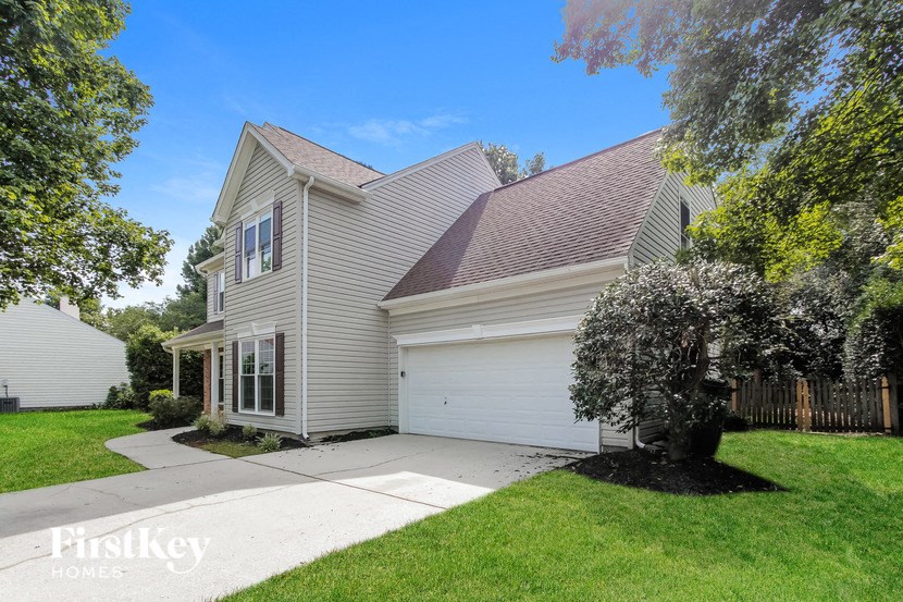 a white house with a yard and a sidewalk
