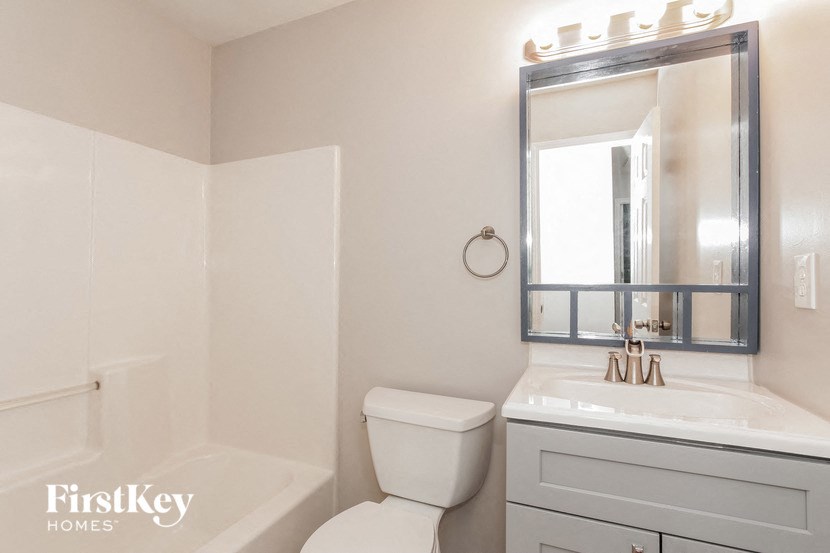 a white bathroom with a toilet and a sink